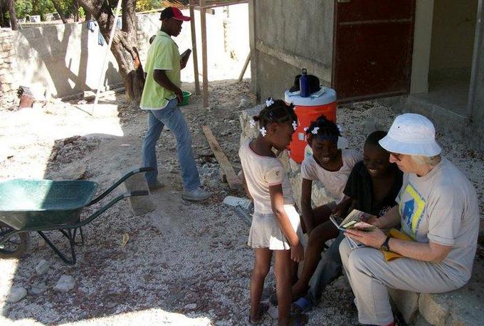 aide showing children a book