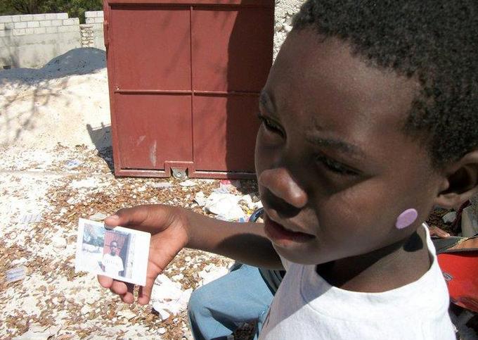 young boy holding picture